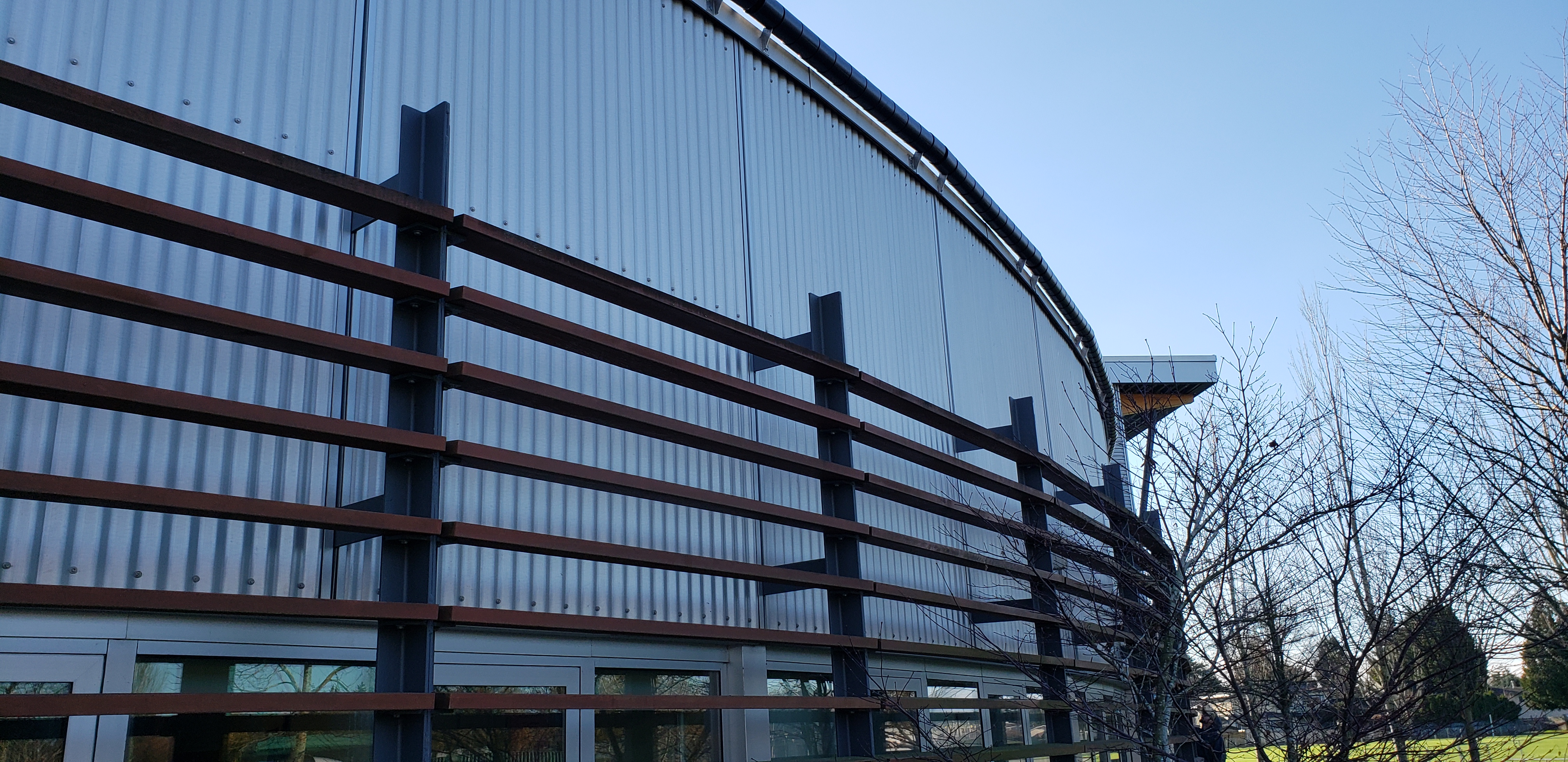 Low-profile anti-access roller system installed on an architectural building parapet