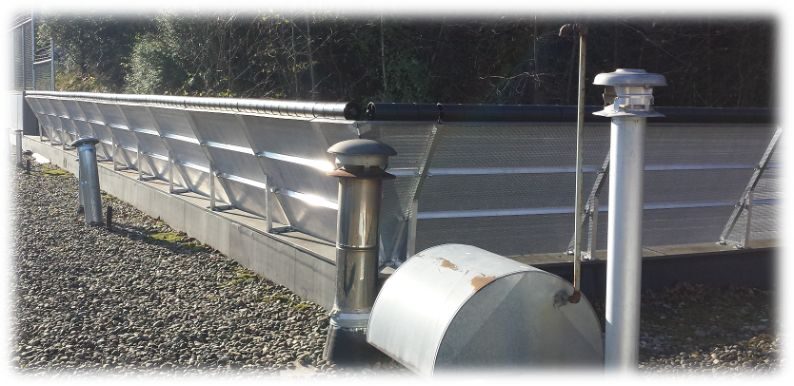 Non-penetrating counter-weighted roof guardrail installed along a commercial rooftop edge
