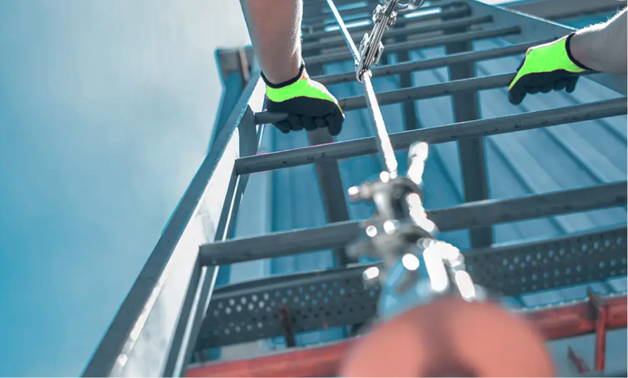 Rigid-rail vertical fall-arrest system installed on a fixed industrial ladder