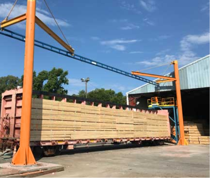 Overhead rigid-track fall protection system mounted above a vehicle maintenance bay